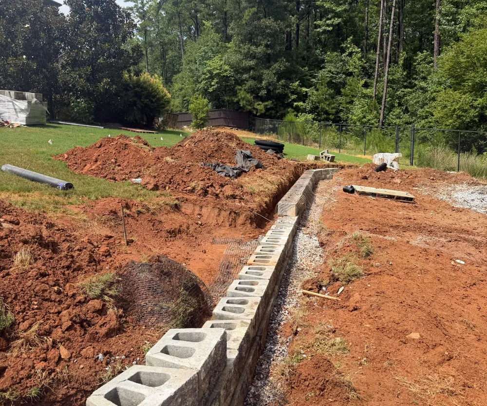 Long masonry retaining wall project under construction
